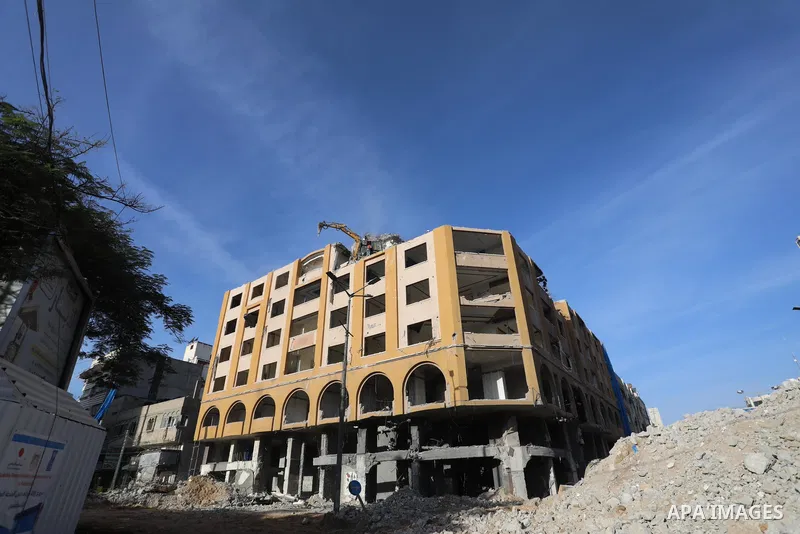 Palestinian workers remove the rubbles of al-Jawhara tower which was hit by Israeli strikes during the recent 11-day conflict between Israel and Hamas on May, in Gaza city on November 25, 2021. People and businesses in t...