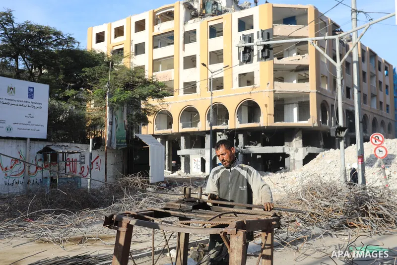 Palestinian workers remove the rubbles of al-Jawhara tower which was hit by Israeli strikes during the recent 11-day conflict between Israel and Hamas on May, in Gaza city on November 25, 2021. People and businesses in t...
