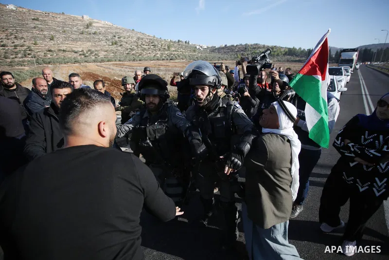 Israeli security forces block parents of Palestinian pupils protesting after their children were prevented from heading to school, as Israeli settlers block the village entrance in al-Lubban al-Sharqiya, south of the Wes...