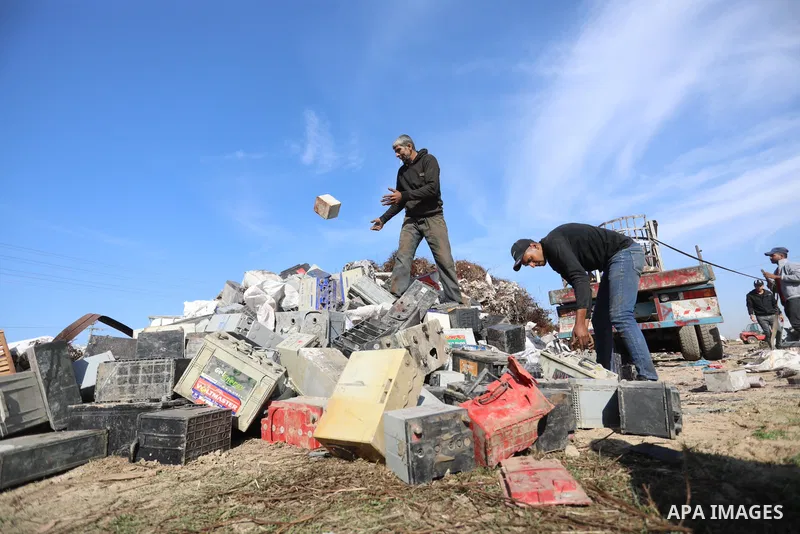 A Palestinian worker sorts through electronic waste such as batteries, a popular product in the midst of Gaza’s electricity crisis, after Israeli authorities prevented the export of 25,000 tons of damaged batteries, in J...