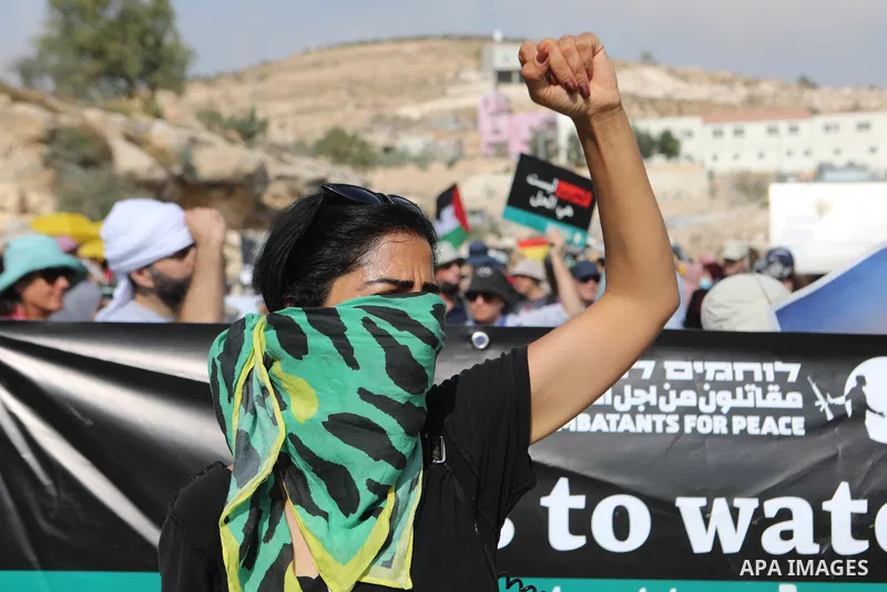 Palestinian demonstrators and Israeli activists, take part in a demonstration against Israeli land confiscation and the cutting of water supply for Palestinians villages, in the southern area of the West bank town of Heb...