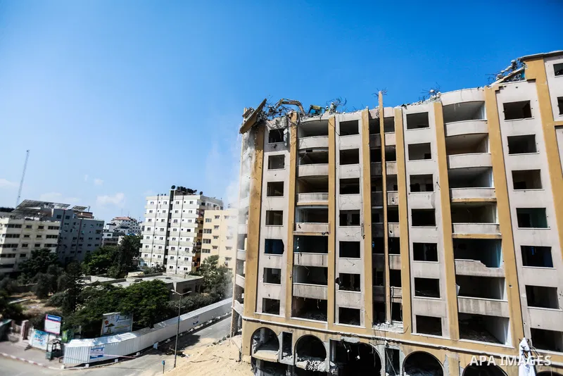 Palestinian workers remove the rubbles of al-Jawhara tower which was hit by Israeli strikes during the recent 11-day conflict between Israel and Hamas on May, in Gaza city on October 02, 2021. The tower was bombed with m...