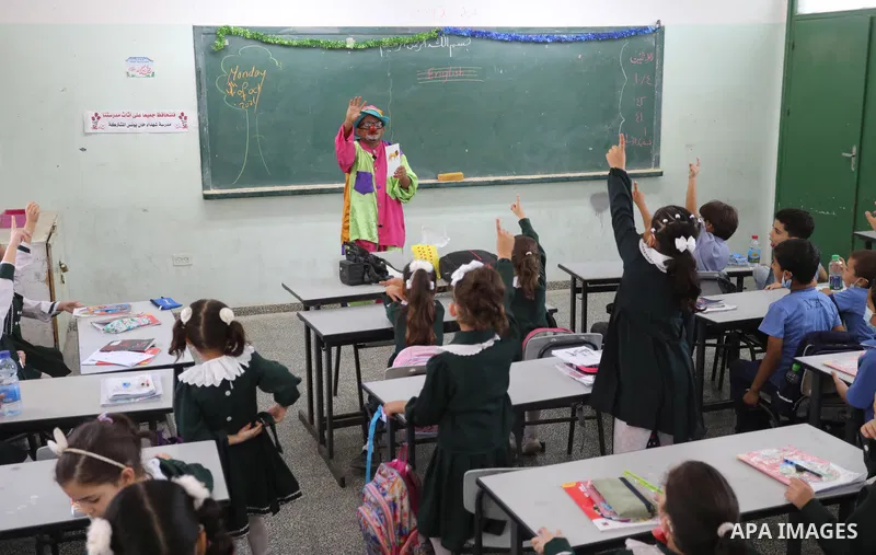 A Palestinian English language teacher, Louay Sheikh Eid, dressed as a clown while teaching school students, in Khan Younis in the southern Gaza strip on October 4, 2021. Sheikh Eid said that he started using this method...