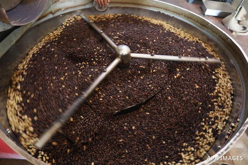 Palestinian men work at a coffee factory in Gaza city on October 6, 2021. 6 tons of coffee are consumed in Gaza strip daily. More than six different companies compete in the coffee production business in Gaza. The increa...