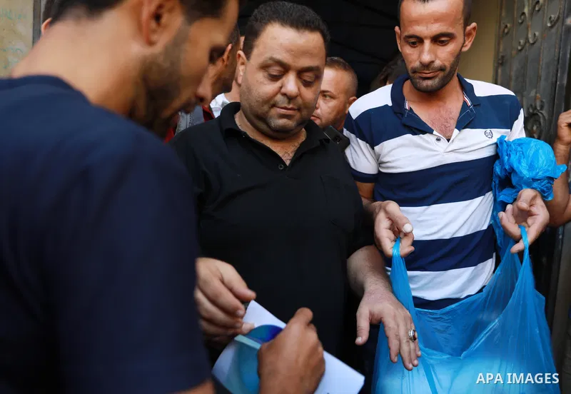 Palestinian citizens waiting in front of the Gaza Chamber of Commerce and Industry ​headquarters to register in order to work inside the Israel territories, in Jabalia, northern Gaza Strip, on October, 06 2021. The Gaza...
