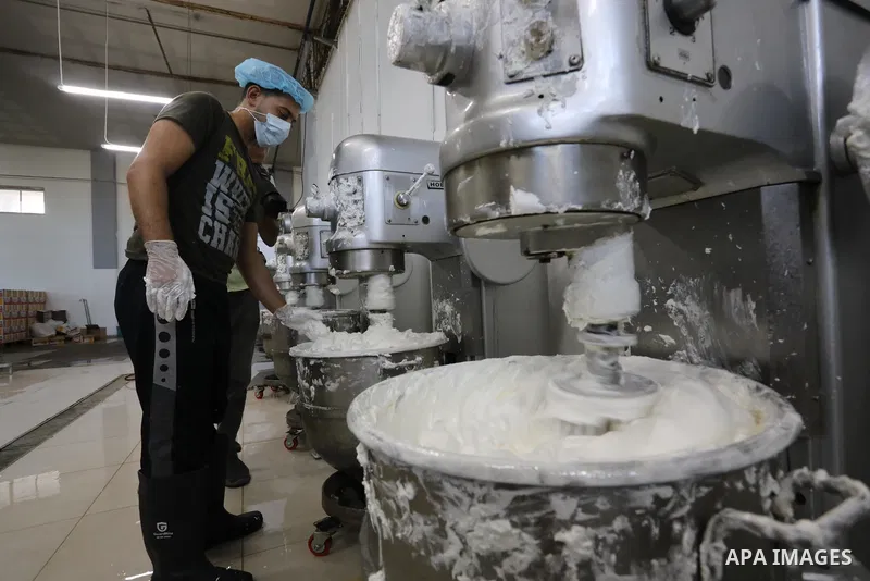 Palestinian workers prepare the vanilla candy known as "Ras El-abed or Shatawi" in the sweet factory , in Deir al-Balah, central Gaza Strip on October 7, 2021. “Ras el Abed” means “Head of Slave”. We would often laugh ab...