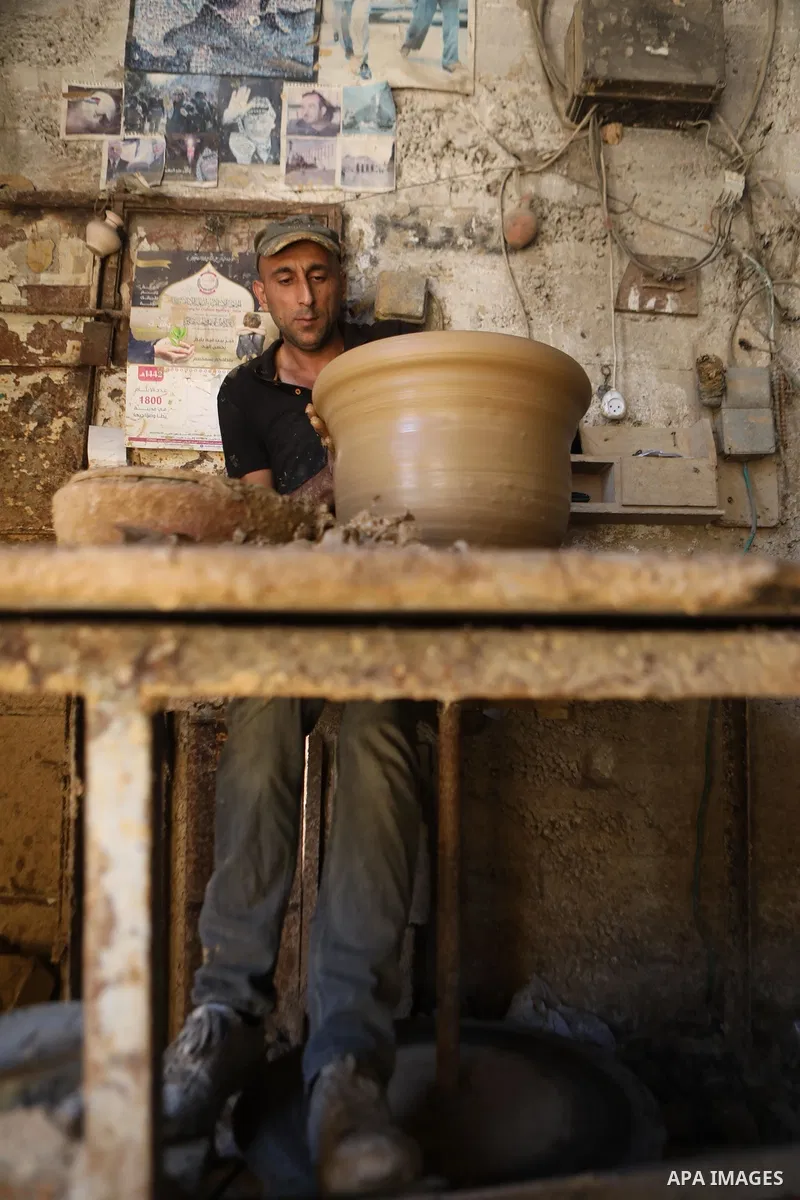 A Palestinian pottery worker makes earthenware vases at a pottery workshop in the West Bank city of Hebron on 07 October 2021. Pottery is a very ancient and traditional industry in Hebron. It has been known since more th...
