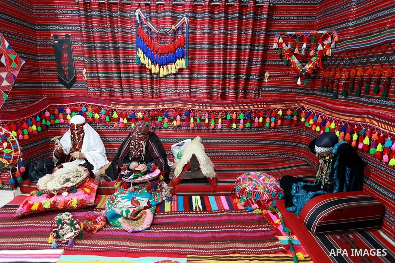 Palestinian Bedouin women weave the traditional products, wool ornaments and carpets, on the National Day of Palestinian Heritage, in Gaza city, on October 7, 2021. Palestinians enjoy a rich cultural heritage. The Palest...