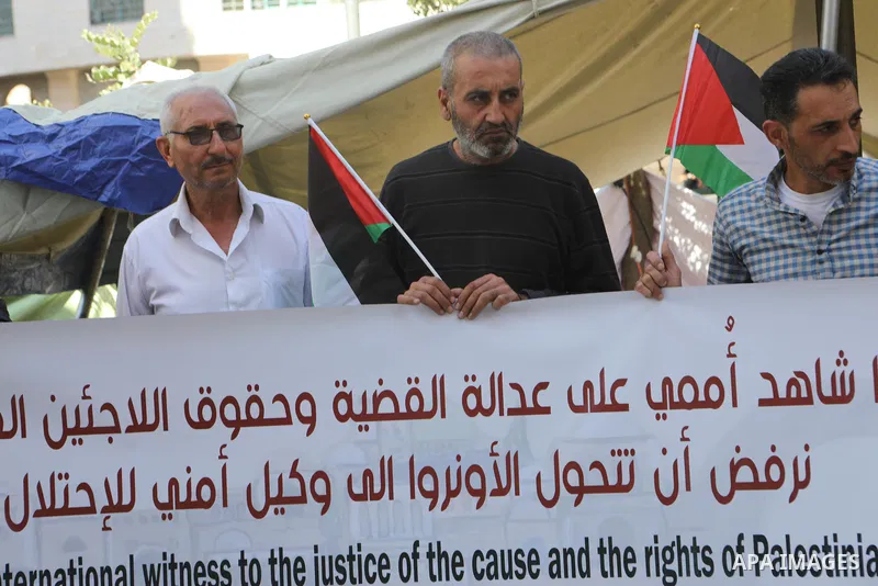 Palestinians take part in a protest against the United States and UNRWA signing a Framework for Cooperation, in the West Bank city of Hebron on October 07, 2021. The Framework for Cooperation states, “The US will not mak...