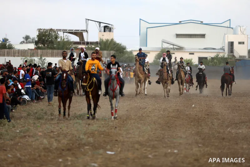 Palestinians ride horses and camels during a local race, in Nuseirat, in the center of Gaza strip on October 8, 2021. Breeders of Arabian horses in Gaza have been struggling to secure the necessary medicines and vaccinat...