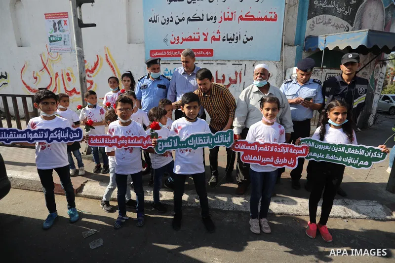 Palestinian children tak epart in a scene entitled "Enough Accidents" in Gaza City on October 09, 2021. Dealing with traffic accident cases and their repercussions does not fall under the Traffic Law only, but also under...