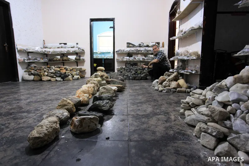 Palestinian man Salah al-Kahlout, 53, displays semi-precious stones at the Palestine Center, in Jabalia camp, in the northern Gaza Strip, on Ocotber 11, 2021. Al-Kahlout collects semi-precious stones to know their name a...