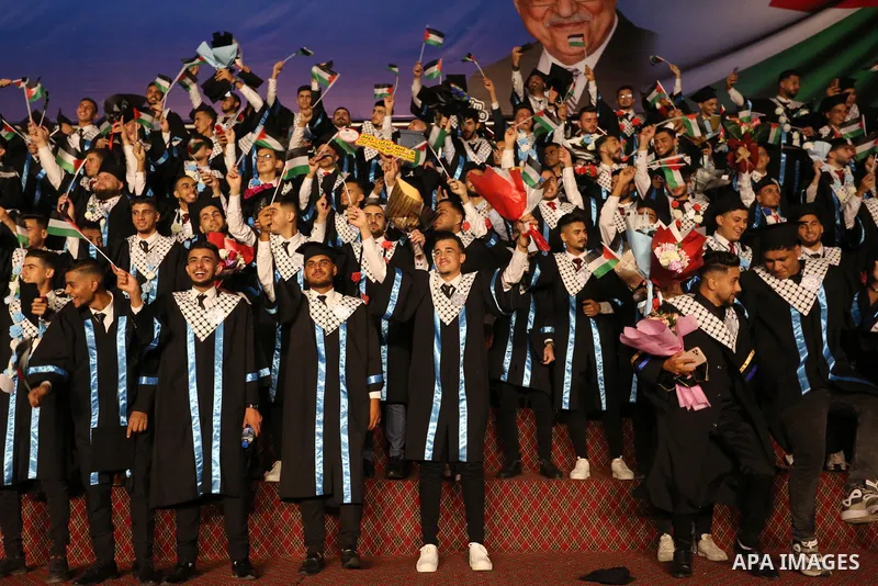 Palestinian students from al-Azhar University attend their graduation ceremony, in Gaza city on October 12, 2021. Photo by Ashraf Amra