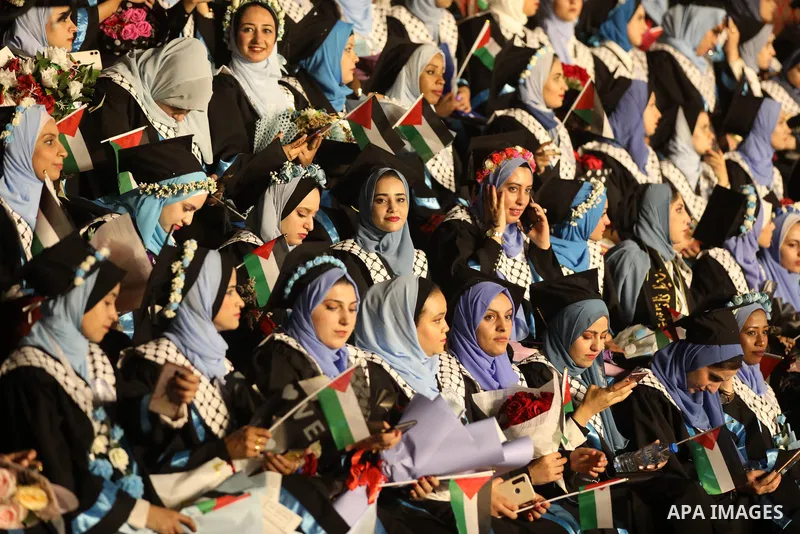 Palestinian students from al-Azhar University attend their graduation ceremony, in Gaza city on October 12, 2021. Photo by Ashraf Amra