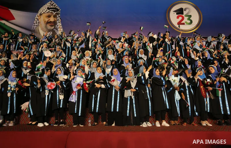 Palestinian students from al-Azhar University attend their graduation ceremony, in Gaza city on October 12, 2021. Photo by Ashraf Amra