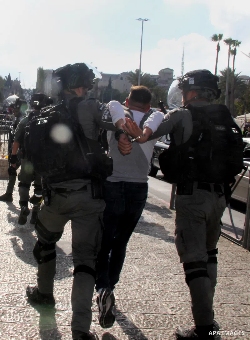 Israeli forces detain a Palestinian protester during clashes near Damascus Gate just outside Jerusalem's Old City, on October 18, 2021. Photo by Mahfouz Abu Turk