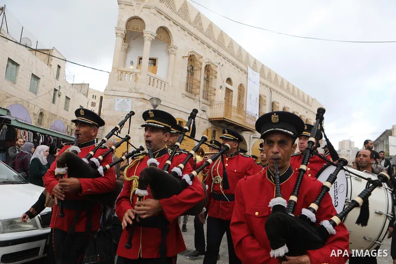Palestinian Muslims celebrate at streets near the Ibrahimi Mosque or the Tomb of the Patriarchs, during a festival of Eid-e-Milad-ul-Nabi, the birth anniversary of the Prophet Mohammad in the West Bank city of Hebron on...