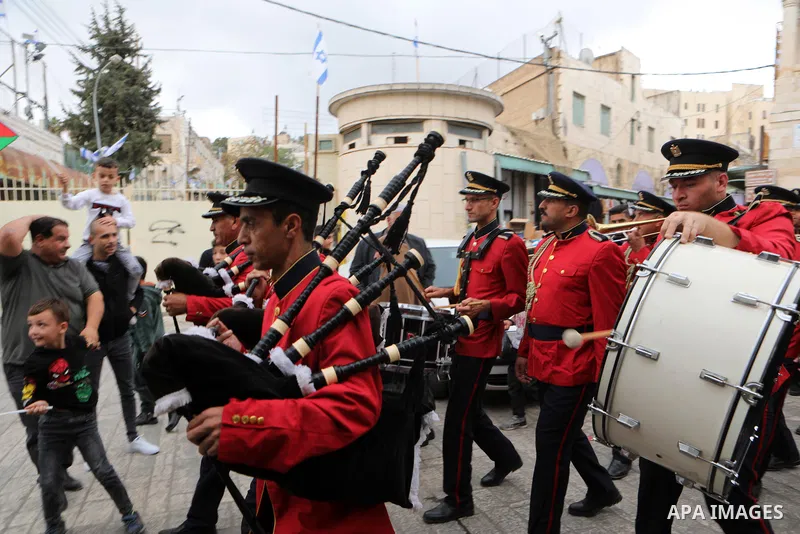 Palestinian Muslims celebrate at streets near the Ibrahimi Mosque or the Tomb of the Patriarchs, during a festival of Eid-e-Milad-ul-Nabi, the birth anniversary of the Prophet Mohammad in the West Bank city of Hebron on...