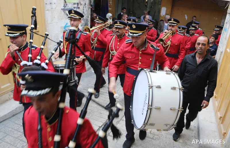 Palestinian Muslims celebrate at streets near the Ibrahimi Mosque or the Tomb of the Patriarchs, during a festival of Eid-e-Milad-ul-Nabi, the birth anniversary of the Prophet Mohammad in the West Bank city of Hebron on...