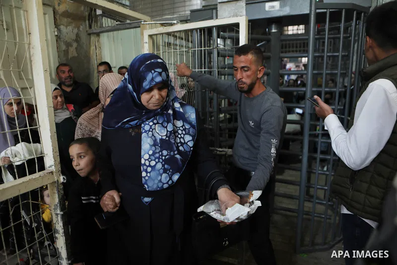 Palestinian Muslims cross a gate of the Ibrahimi Mosque or the Tomb of the Patriarchs to attend a festival of Eid-e-Milad-ul-Nabi, the birth anniversary of the Prophet Mohammad in the West Bank city of Hebron on October...