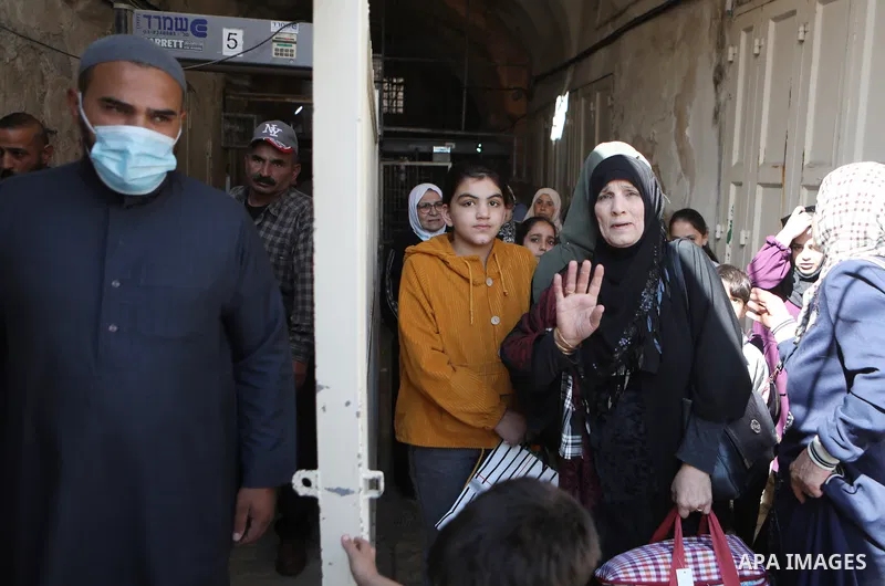 Palestinian Muslims cross a gate of the Ibrahimi Mosque or the Tomb of the Patriarchs to attend a festival of Eid-e-Milad-ul-Nabi, the birth anniversary of the Prophet Mohammad in the West Bank city of Hebron on October...