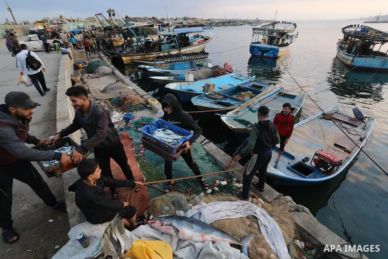 Palestinian fishermen sell fish at Gaza City's main port on October 21, 2021. Fishing is a major source of revenue for the impoverished Palestinian enclave. Israel, which maintains a blockade on Gaza strip, has over the...