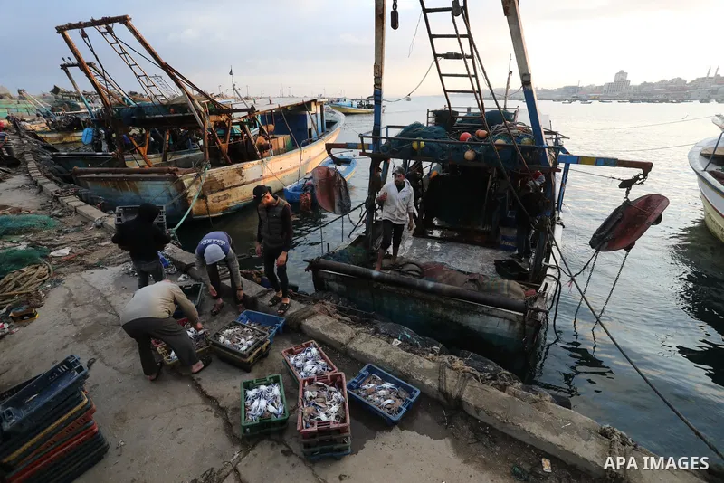 Palestinian fishermen sell fish at Gaza City's main port on October 21, 2021. Fishing is a major source of revenue for the impoverished Palestinian enclave. Israel, which maintains a blockade on Gaza strip, has over the...
