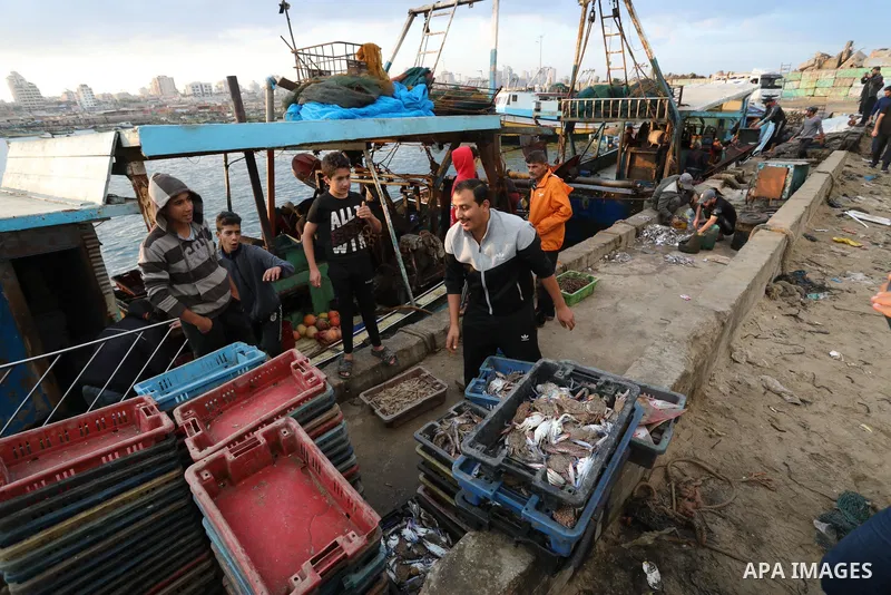 Palestinian fishermen sell fish at Gaza City's main port on October 21, 2021. Fishing is a major source of revenue for the impoverished Palestinian enclave. Israel, which maintains a blockade on Gaza strip, has over the...