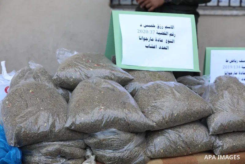 Members of Palestinian anti-drug police display the drugs during a press conference for the destruction of narcotics, in Gaza City on October 21, 2021. Photo by Ashraf Amra