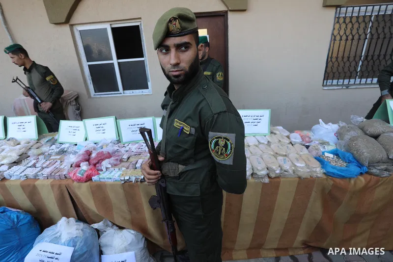 Members of Palestinian anti-drug police display the drugs during a press conference for the destruction of narcotics, in Gaza City on October 21, 2021. Photo by Ashraf Amra