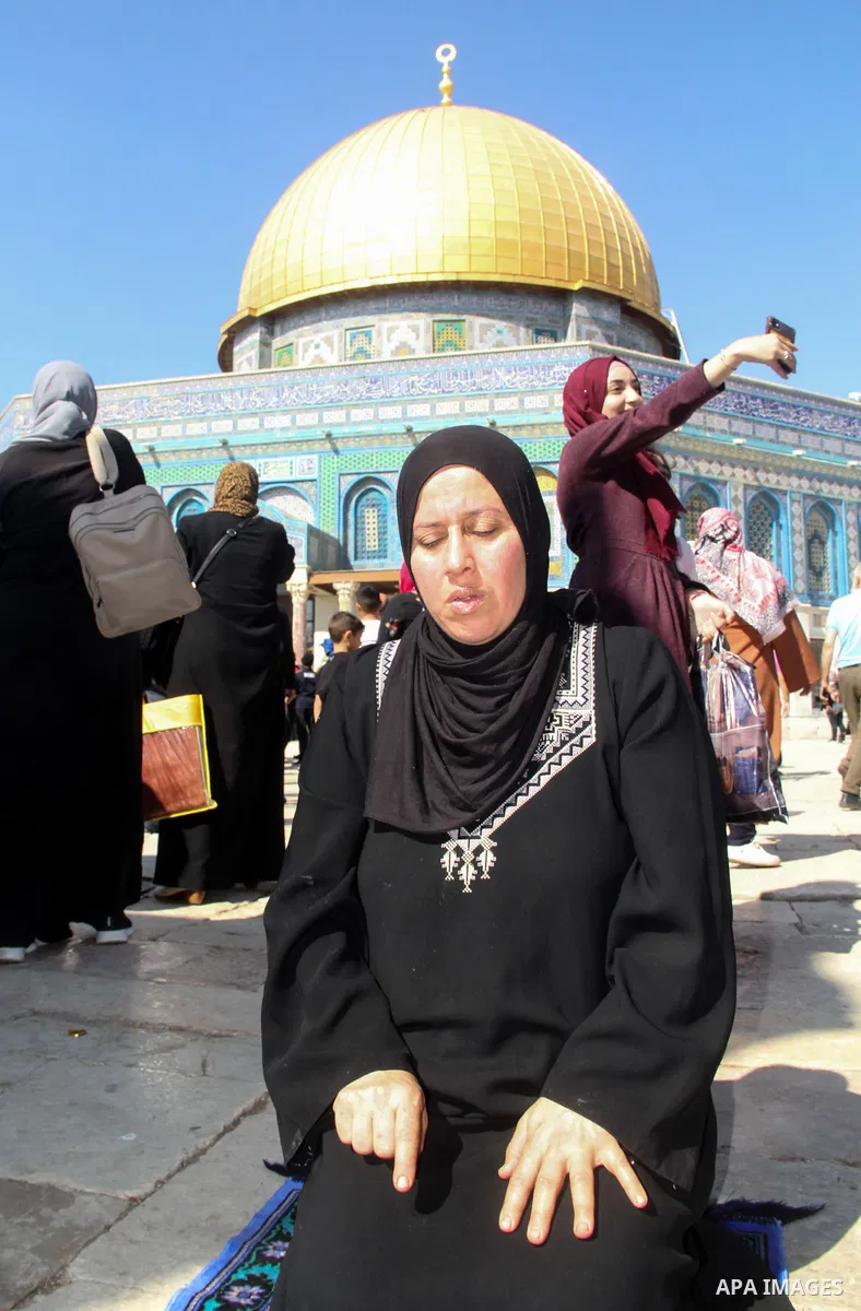 Palestinian Muslim worshippers perform the Friday prayers in front of the Dome of the Rock mosque in Jerusalem's Old City's al-Aqsa mosque compound, on October 22, 2021. Photo by Mahfouz Abu Turk