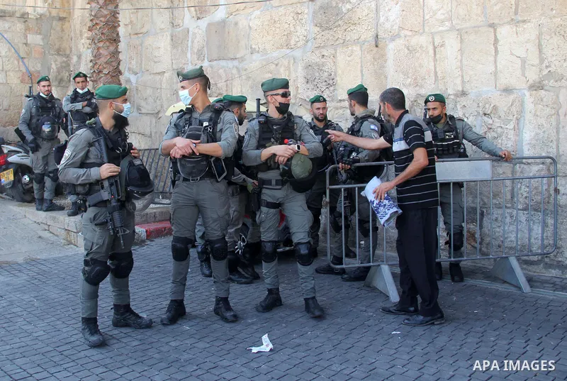 Israeli policemen stand guard as Palestinian Muslim worshippers perform the Friday prayers in front of the Dome of the Rock mosque in Jerusalem's Old City's al-Aqsa mosque compound, on October 22, 2021. Photo by Mahfouz...
