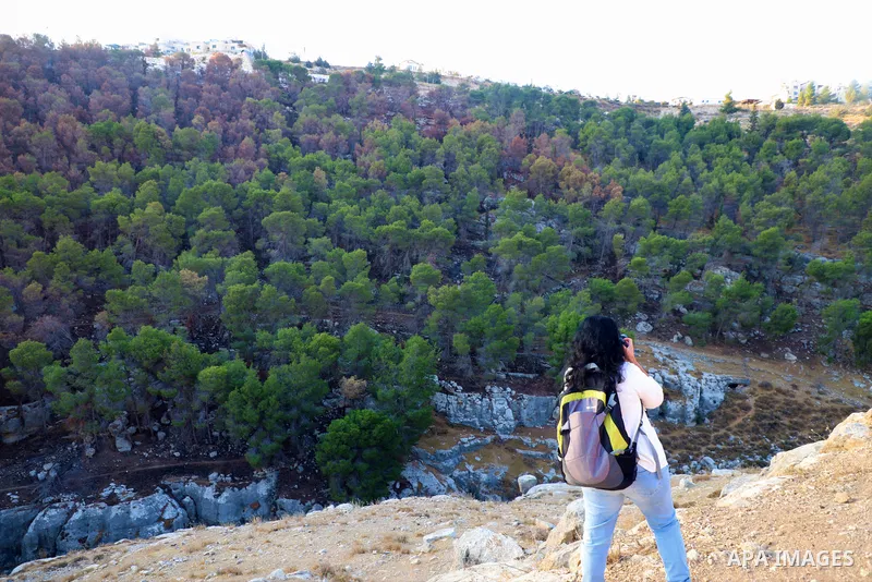 Palestinian adventurers walk amid dangerous cliffs during their journey to explore Valley and Cave of Saint Khreitoun near the West Bank city of Bethlehem, on October 25, 2021. To the southeast of Bethlehem, between the...
