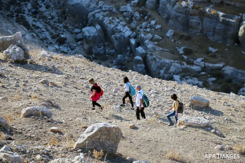 Palestinian adventurers walk amid dangerous cliffs during their journey to explore Valley and Cave of Saint Khreitoun near the West Bank city of Bethlehem, on October 25, 2021. To the southeast of Bethlehem, between the...
