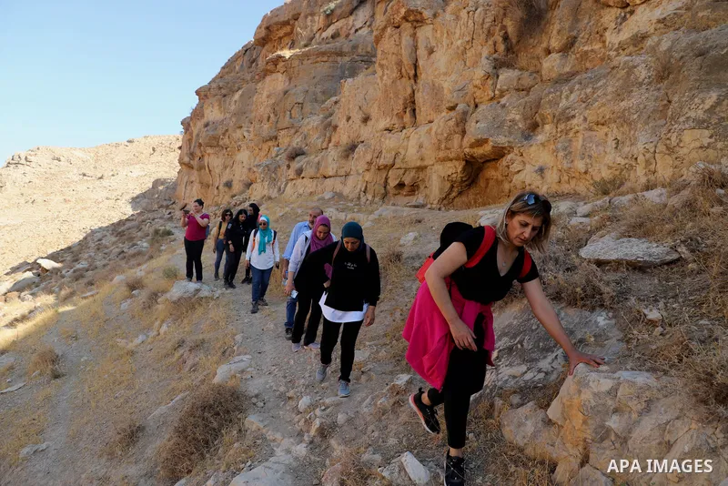 Palestinian adventurers walk amid dangerous cliffs during their journey to explore Valley and Cave of Saint Khreitoun near the West Bank city of Bethlehem, on October 25, 2021. To the southeast of Bethlehem, between the...