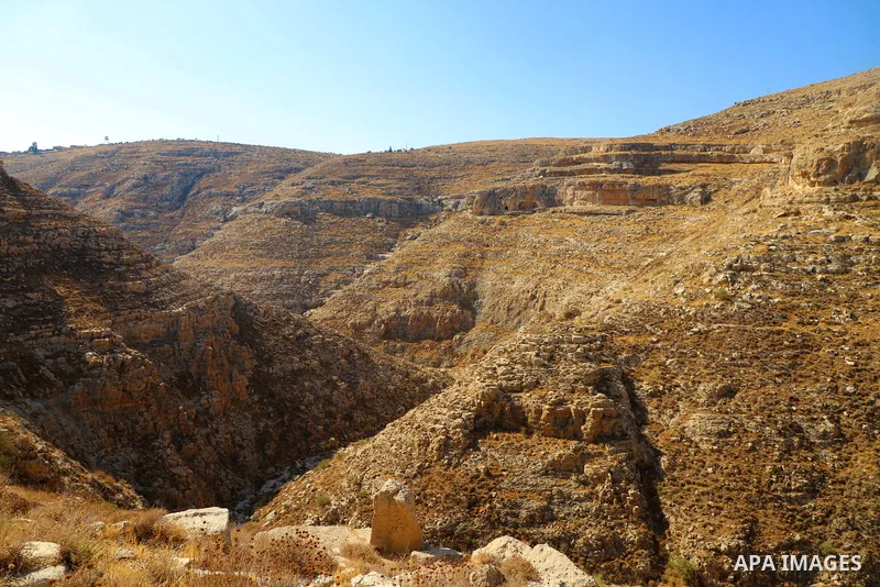 Palestinian adventurers walk amid dangerous cliffs during their journey to explore Valley and Cave of Saint Khreitoun near the West Bank city of Bethlehem, on October 25, 2021. To the southeast of Bethlehem, between the...