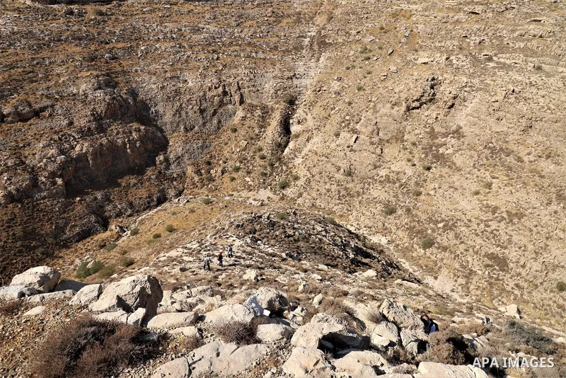 Palestinian adventurers walk amid dangerous cliffs during their journey to explore Valley and Cave of Saint Khreitoun near the West Bank city of Bethlehem, on October 25, 2021. To the southeast of Bethlehem, between the...