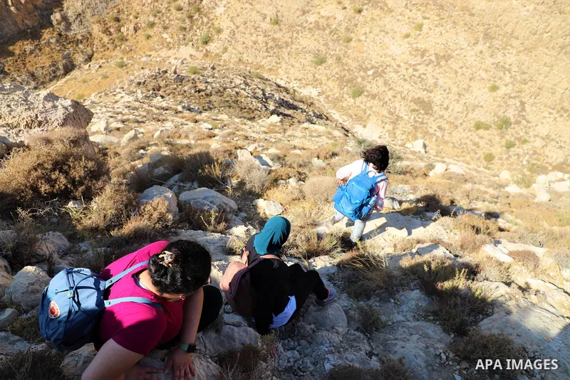 Palestinian adventurers walk amid dangerous cliffs during their journey to explore Valley and Cave of Saint Khreitoun near the West Bank city of Bethlehem, on October 25, 2021. To the southeast of Bethlehem, between the...