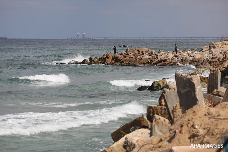 Palestinians enjoy their time at the beach of the Mediterranean sea in Gaza City, on October 23, 2021. Fishing is a major source of revenue for the impoverished Palestinian enclave. Israel, which maintains a blockade on...