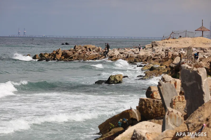 Palestinians enjoy their time at the beach of the Mediterranean sea in Gaza City, on October 23, 2021. Fishing is a major source of revenue for the impoverished Palestinian enclave. Israel, which maintains a blockade on...