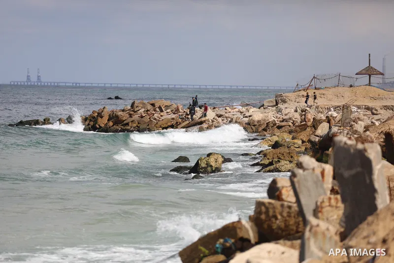 Palestinian fishermen collect fish nets on the beach of the Mediterranean sea in Gaza City, on October 23, 2021. Fishing is a major source of revenue for the impoverished Palestinian enclave. Israel, which maintains a bl...