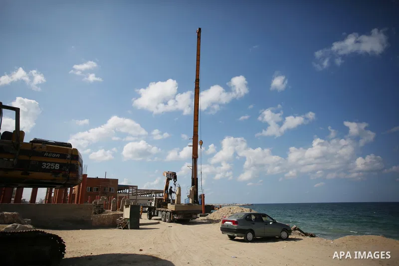 Palestinians work nea the beach of the Mediterranean sea in Gaza City, on October 23, 2021. Fishing is a major source of revenue for the impoverished Palestinian enclave. Israel, which maintains a blockade on Gaza strip,...