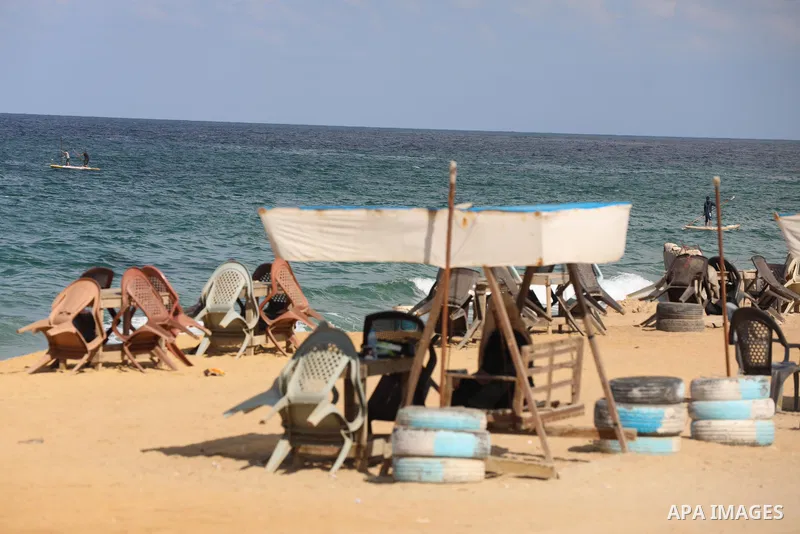 Palestinians enjoy their time at the beach of the Mediterranean sea in Gaza City, on October 23, 2021. Fishing is a major source of revenue for the impoverished Palestinian enclave. Israel, which maintains a blockade on...