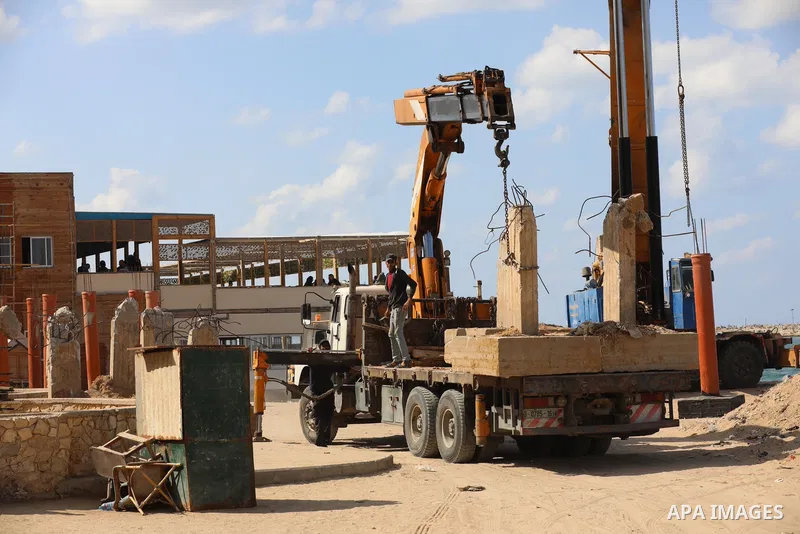 Palestinians work nea the beach of the Mediterranean sea in Gaza City, on October 23, 2021. Fishing is a major source of revenue for the impoverished Palestinian enclave. Israel, which maintains a blockade on Gaza strip,...