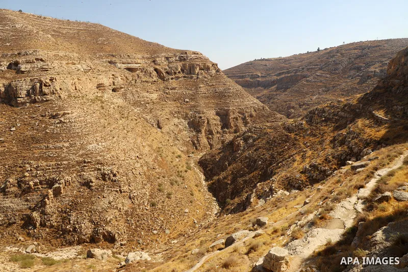 Palestinian adventurers walk amid dangerous cliffs during their journey to explore Valley and Cave of Saint Khreitoun near the West Bank city of Bethlehem, on October 25, 2021. To the southeast of Bethlehem, between the...