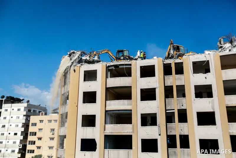 Palestinian workers remove the rubbles of al-Jawhara tower which was hit by Israeli strikes during the recent 11-day conflict between Israel and Hamas on May, in Gaza city on October 23, 2021. The tower was bombed with m...