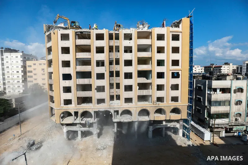 Palestinian workers remove the rubbles of al-Jawhara tower which was hit by Israeli strikes during the recent 11-day conflict between Israel and Hamas on May, in Gaza city on October 23, 2021. The tower was bombed with m...