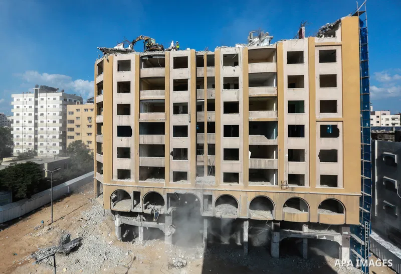 Palestinian workers remove the rubbles of al-Jawhara tower which was hit by Israeli strikes during the recent 11-day conflict between Israel and Hamas on May, in Gaza city on October 23, 2021. The tower was bombed with m...