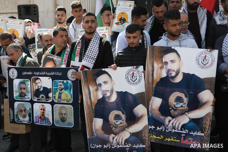 Palestinians take part in a protest in solidarity with prisoners on hunger strike at Israeli jails, in the West Bank city on October 24, 2021. Seven Palestinian prisoners in Israeli detention currently remain on hunger s...