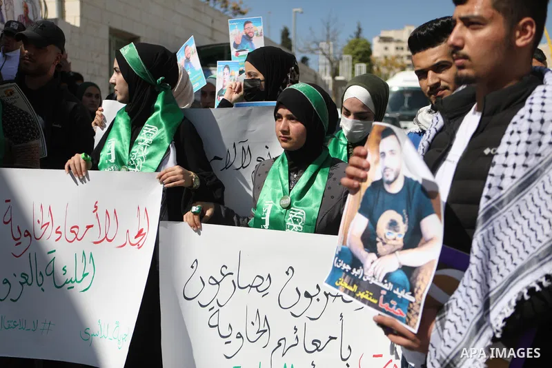 Palestinians take part in a protest in solidarity with prisoners on hunger strike at Israeli jails, in the West Bank city on October 24, 2021. Seven Palestinian prisoners in Israeli detention currently remain on hunger s...